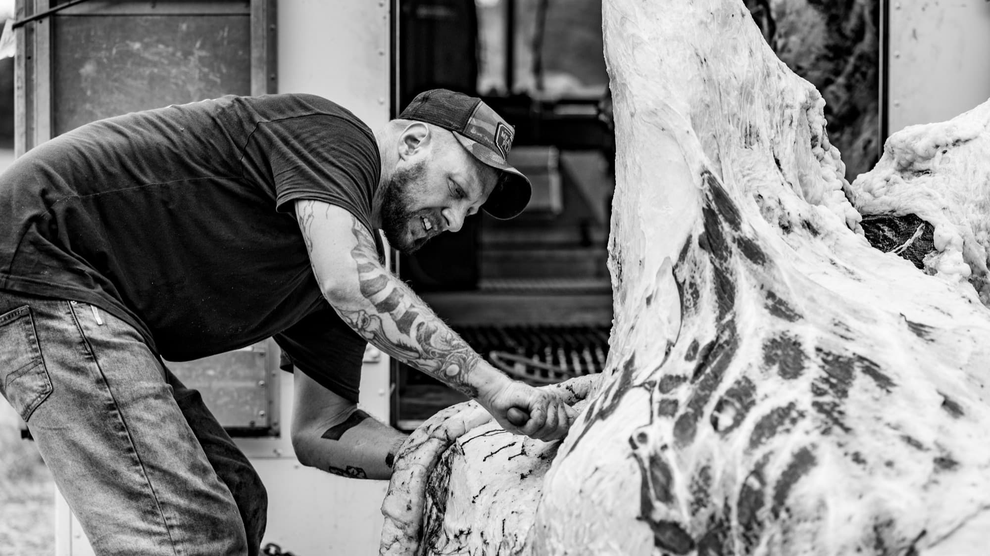 Master butcher breaking down a freshly harvested carcass by hand